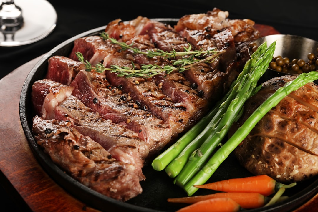 Seared steak and asparagus served in a black carbon steel skillet