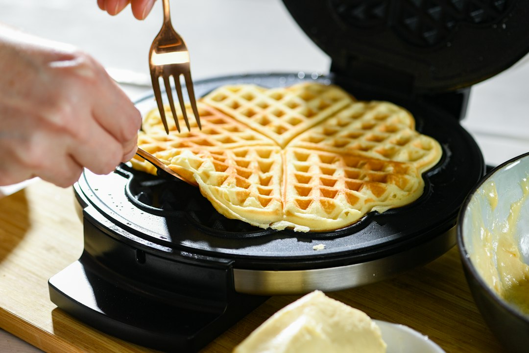 Pouring waffle batter into a hot waffle iron