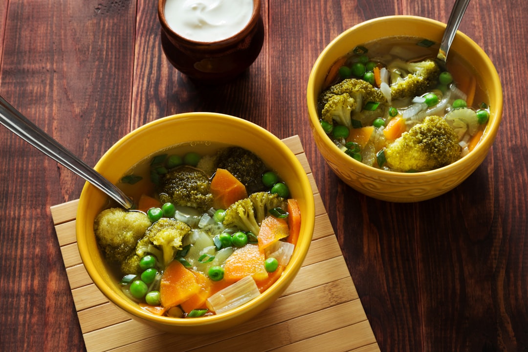 Rustic table set with bowls of vegetable soup