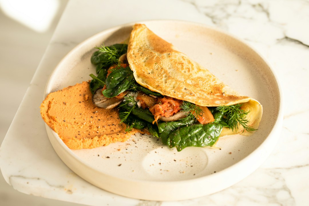 Folded vegetable omelet on a breakfast plate
