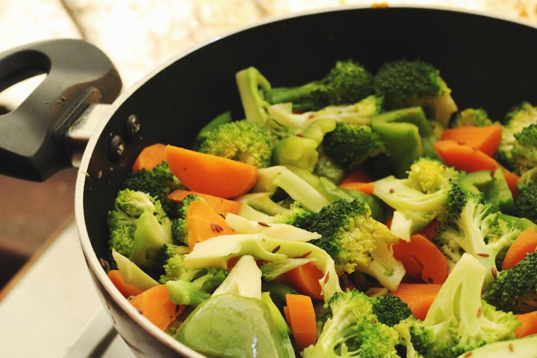 Pot of soup with fresh vegetables simmering on the stove