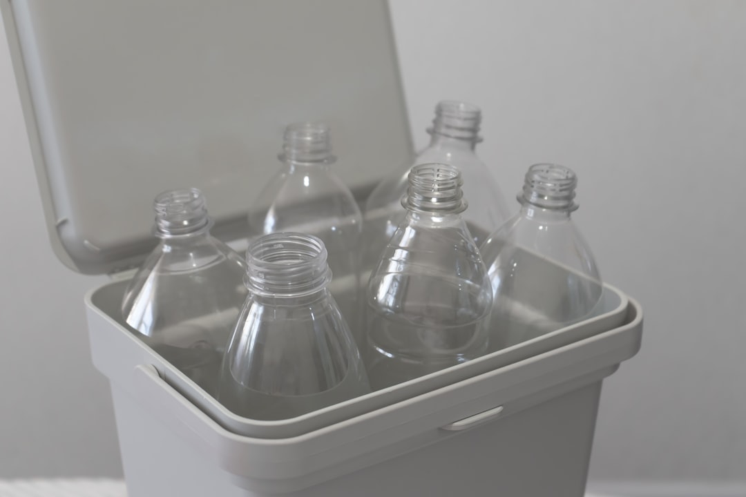 Water bottles standing upright in a storage bin organizer