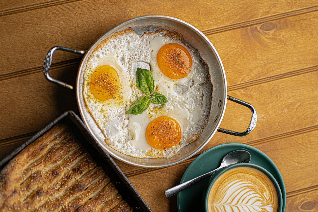 Sunny side up eggs frying in a pan