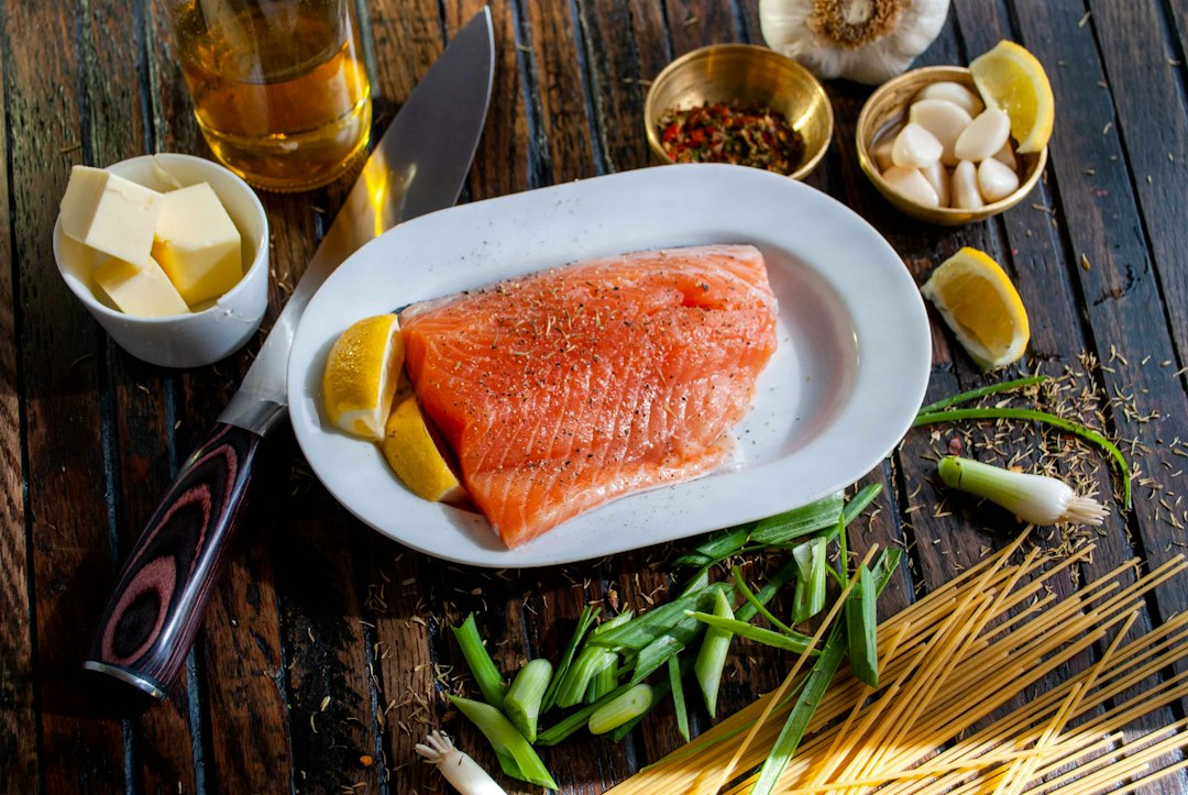 Salmon fillet prepped with herbs and lemon before cooking