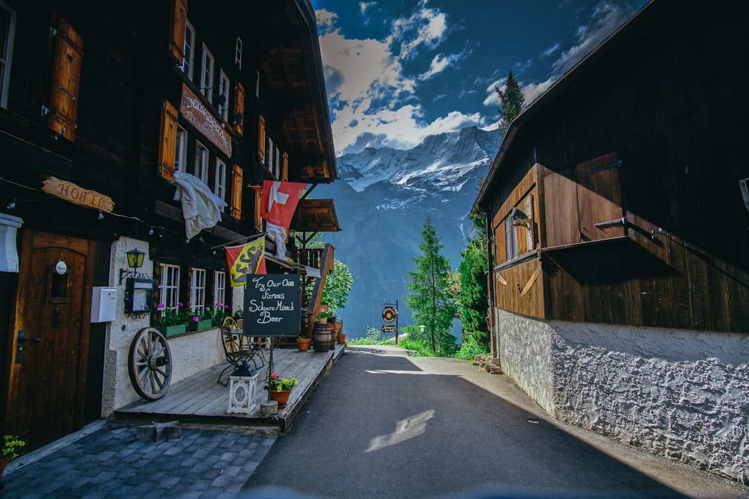 A Swiss alpine village with chalets beneath the mountains, where the raclette tradition was born