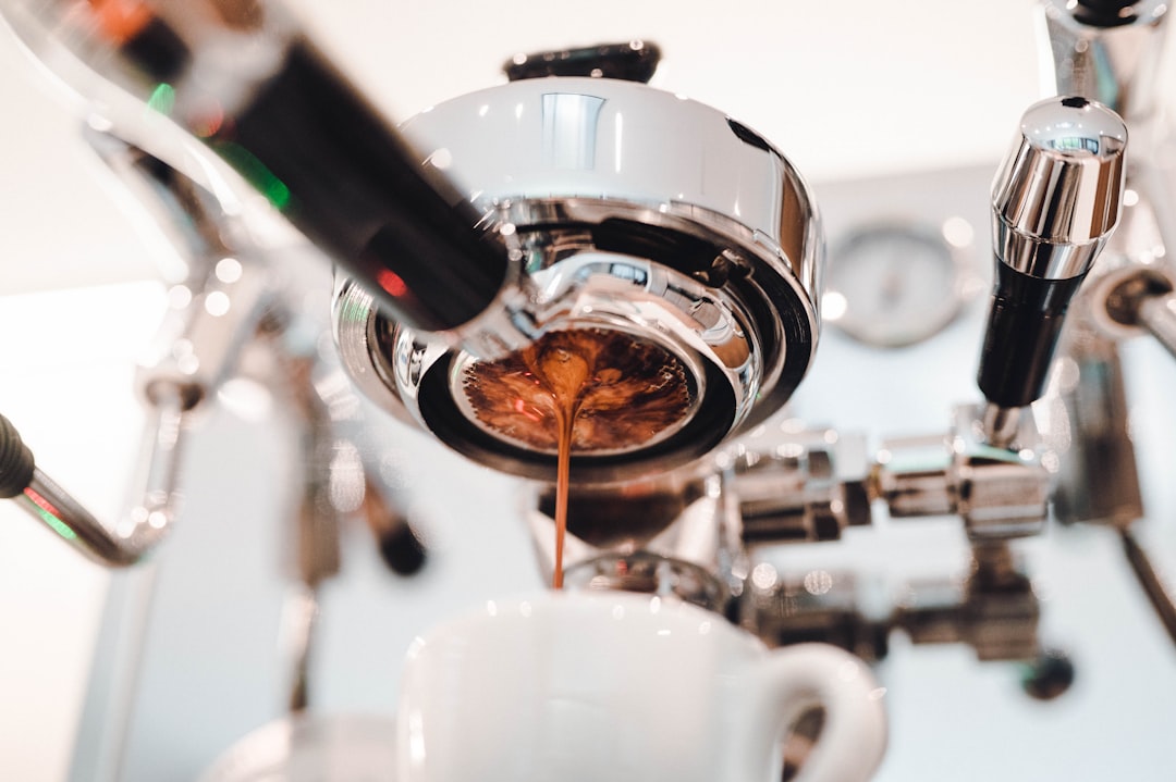 Barista hands with a freshly tamped portafilter of coffee grounds