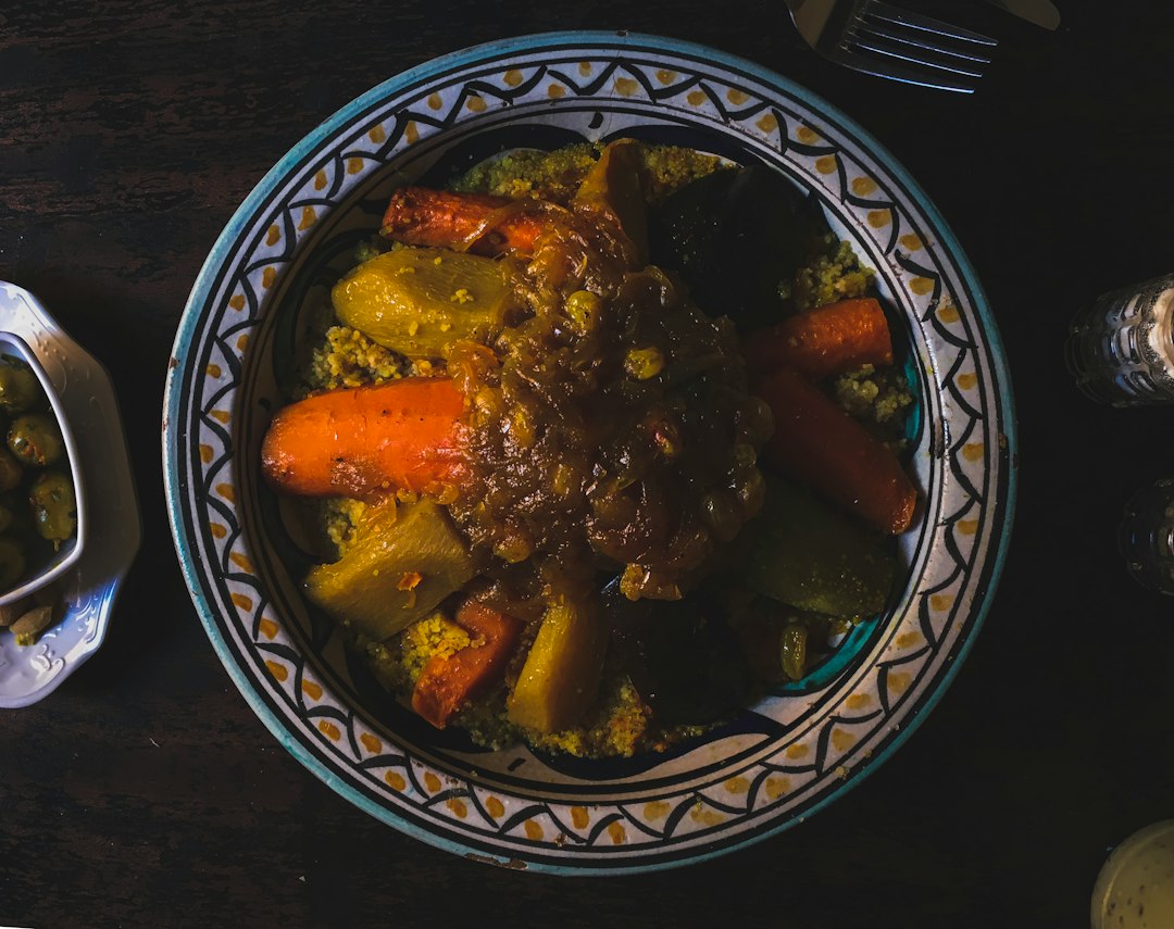 Hearty beef stew served over grains in a bowl