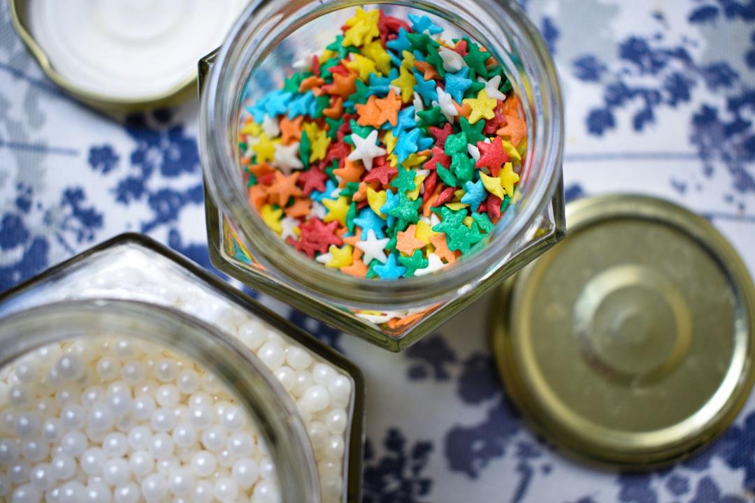 Open glass jars filled with colorful star-shaped sprinkles