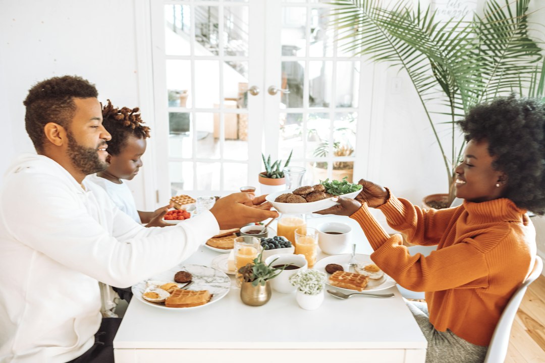 Family gathered around a weekend brunch table with coffee