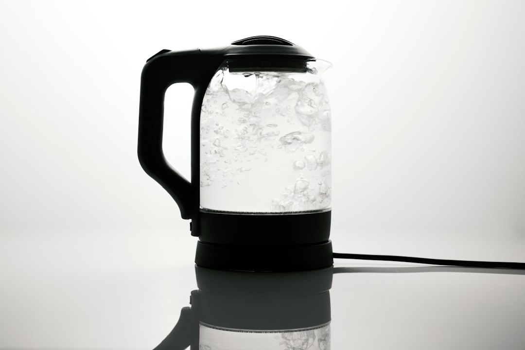 Pouring hot water from an electric kettle