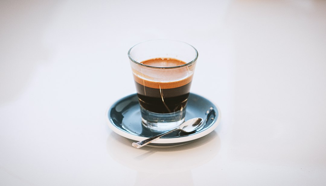 Espresso pouring from a portafilter with thick golden crema