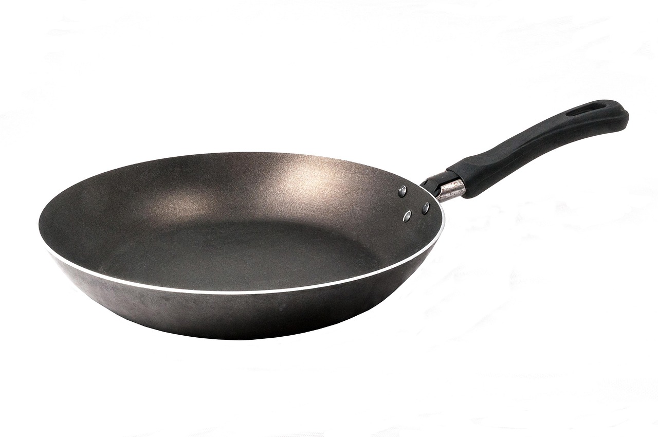 A dark gray nonstick frying pan with a black handle on a white background