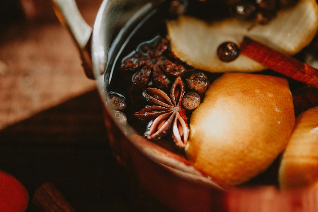 A pot of spiced cider with citrus, cinnamon, and star anise