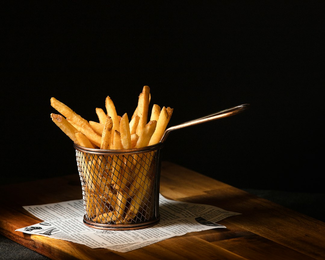 Crispy golden fries served in a metal basket