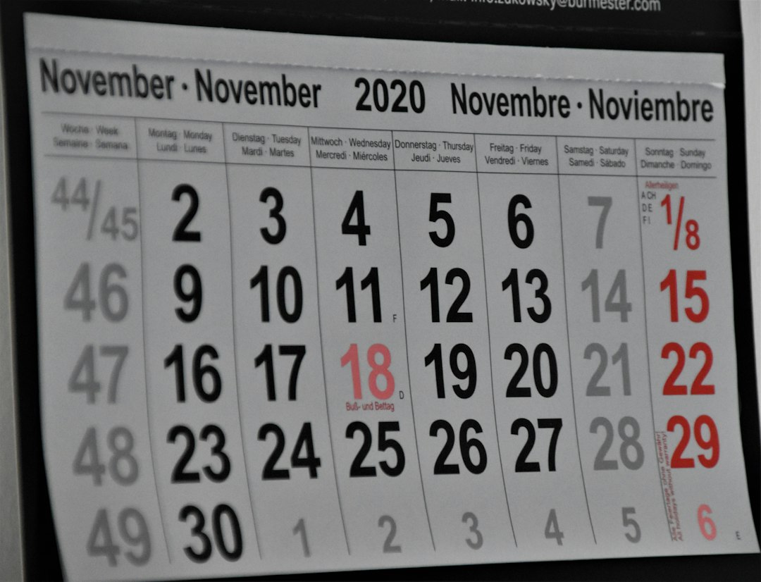 A monthly wall calendar with dates marked for family plans and deadlines