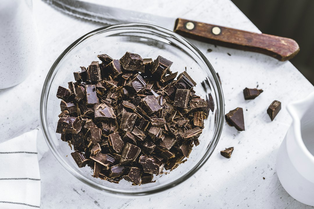 Chopped dark chocolate in a glass bowl