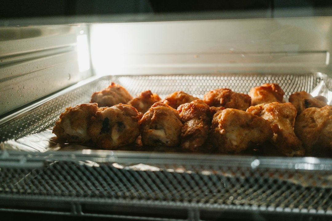 Air fryer holding a batch of crispy fried chicken in its basket