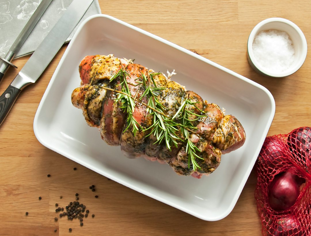 Herb-crusted roasted pork tenderloin ready to slice