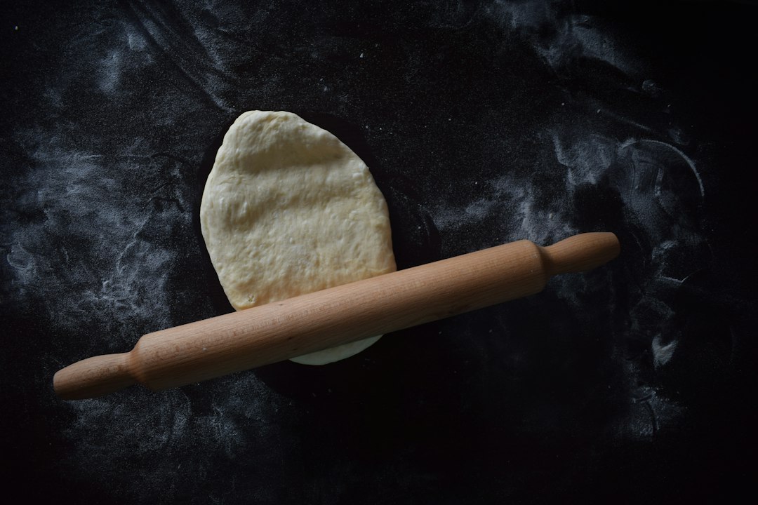 Tapered French rolling pin resting on a floured work surface