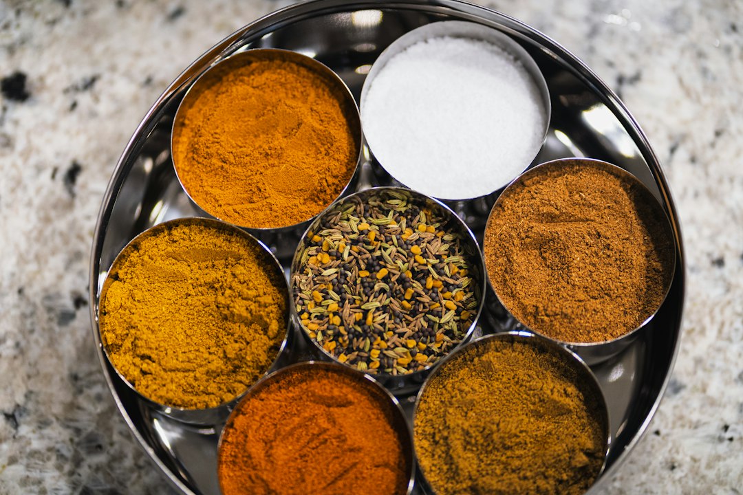 Tray of small bowls with salt, spices, and seeds ready for seasoning