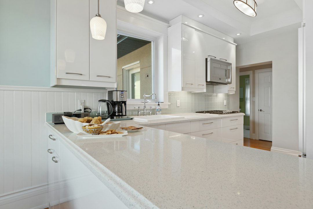 A bright kitchen with a clear countertop and coffee station, the calm after a landing zone reset