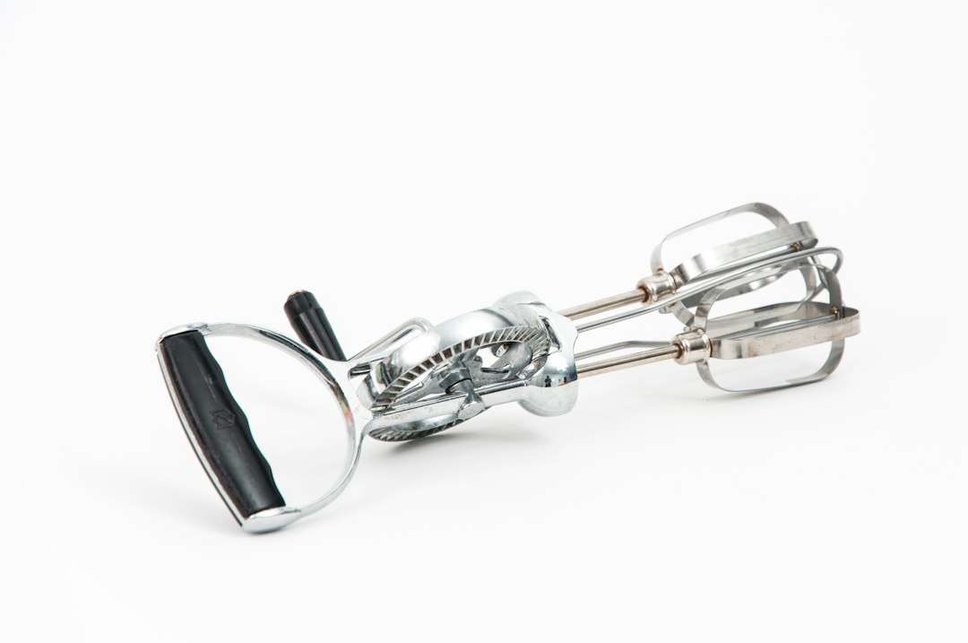 vintage hand-crank egg beater on a counter