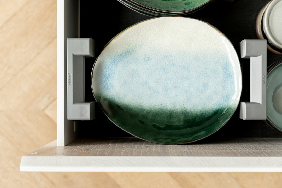 A ceramic plate resting in a drawer organizer