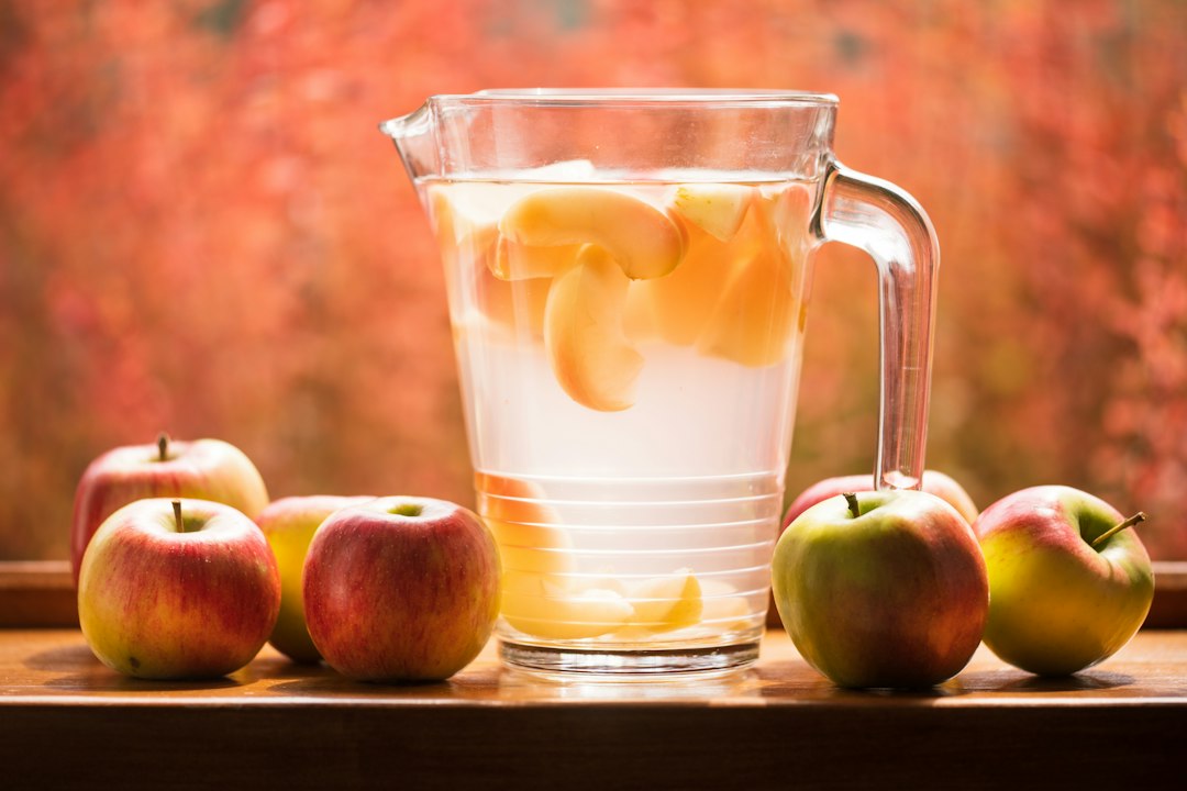 Glass jug of fresh apple cider on a counter