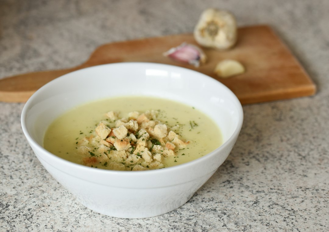 A smooth pale soup in a white bowl, the texture a food mill is built for
