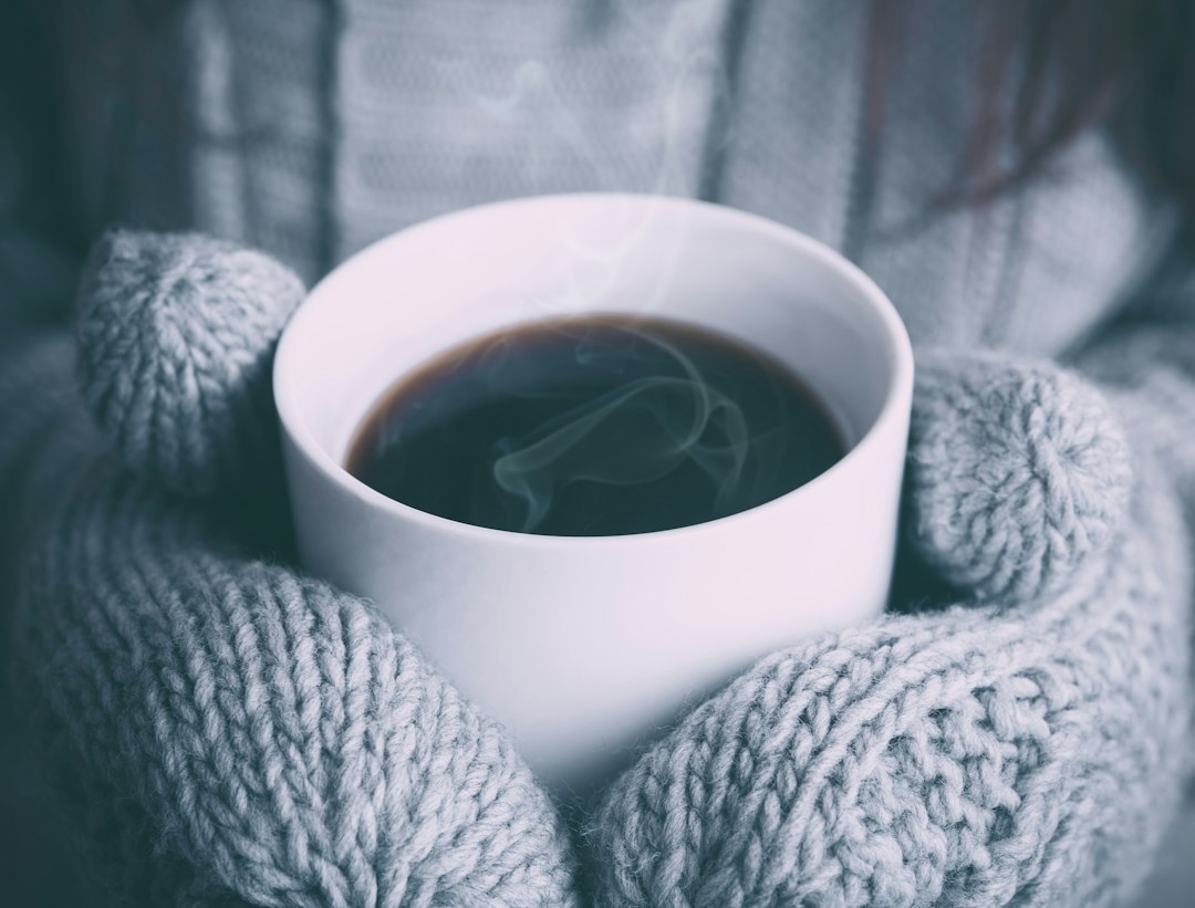 Warm mug held in hands on a cold day