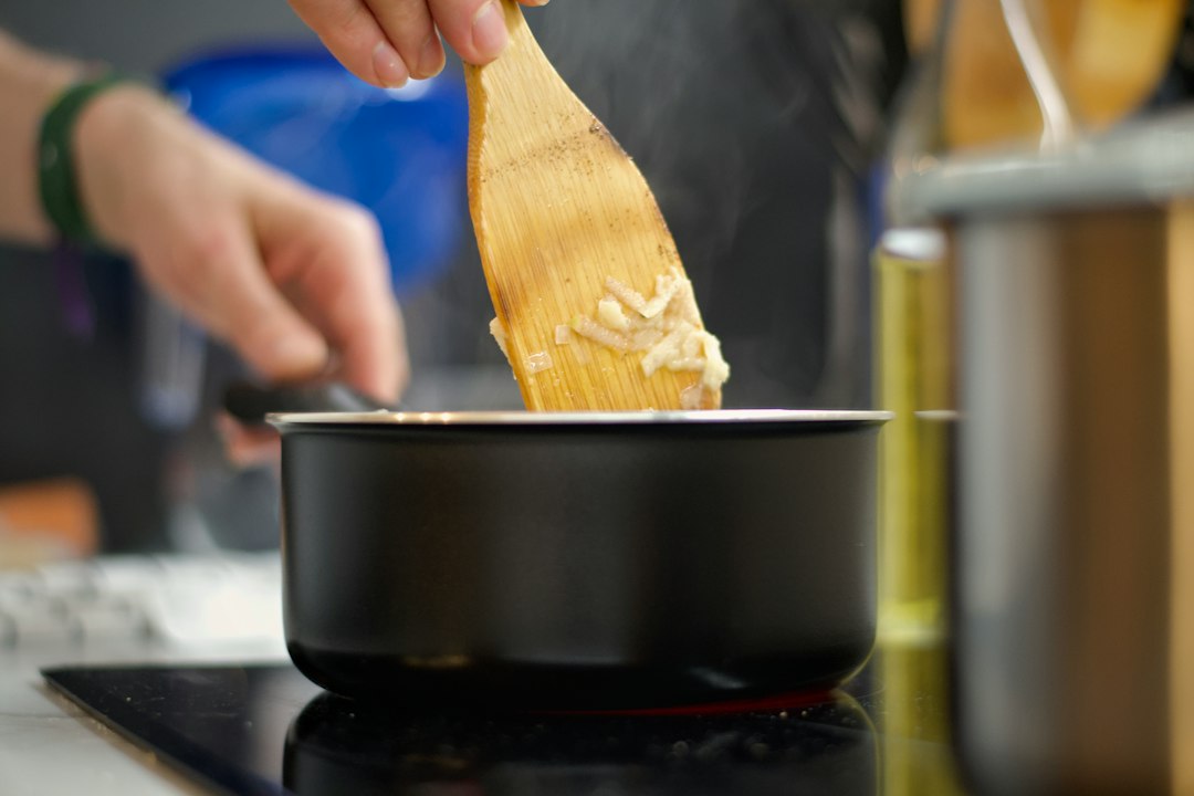 A saucepan on the stove with aromatics being warmed before they meet the potatoes