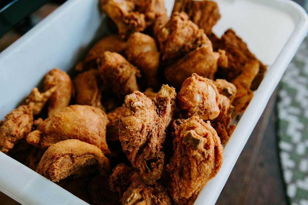 A white tray piled high with crisp, golden fried chicken pieces