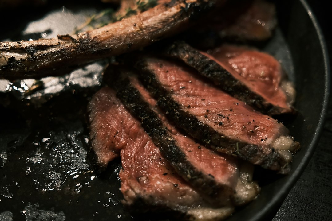Steak sizzling in a hot cast iron pan