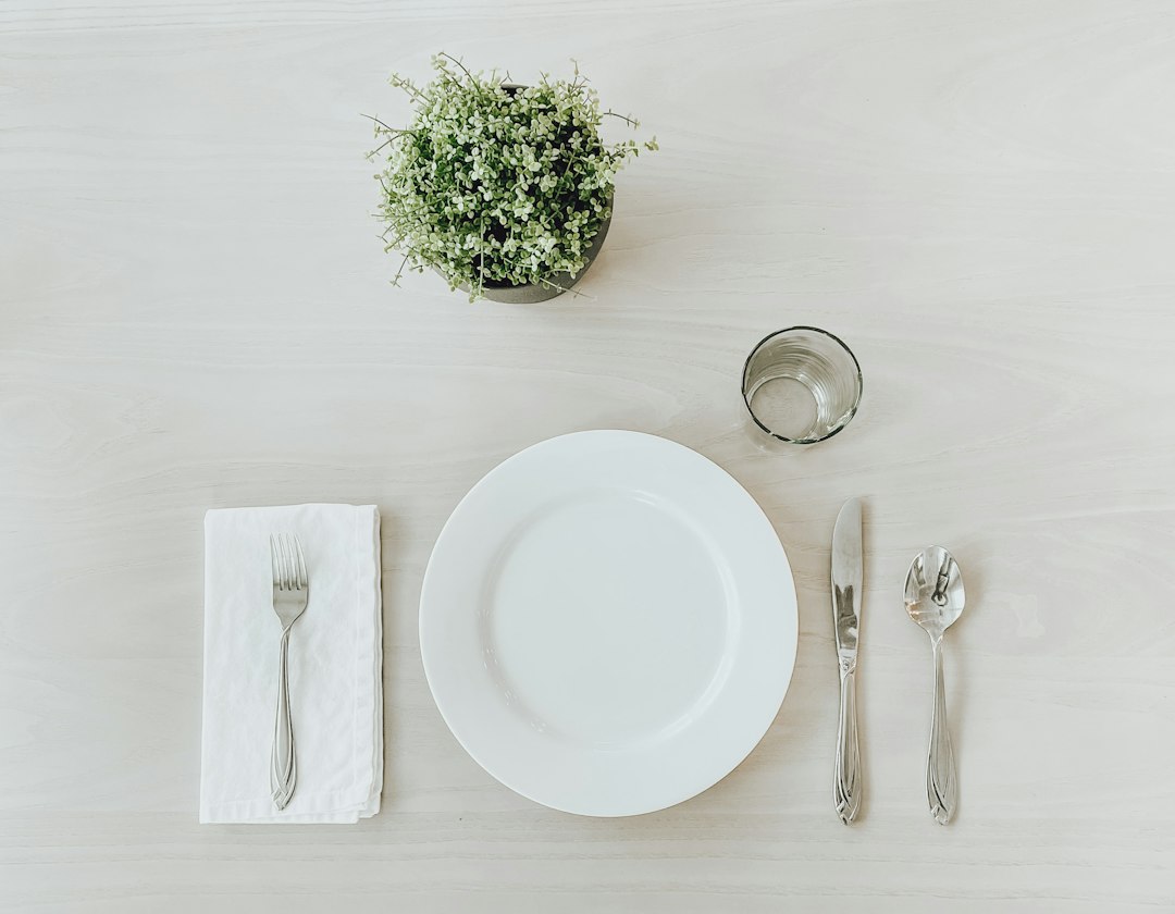 A simple table setting with plate, napkin and silverware